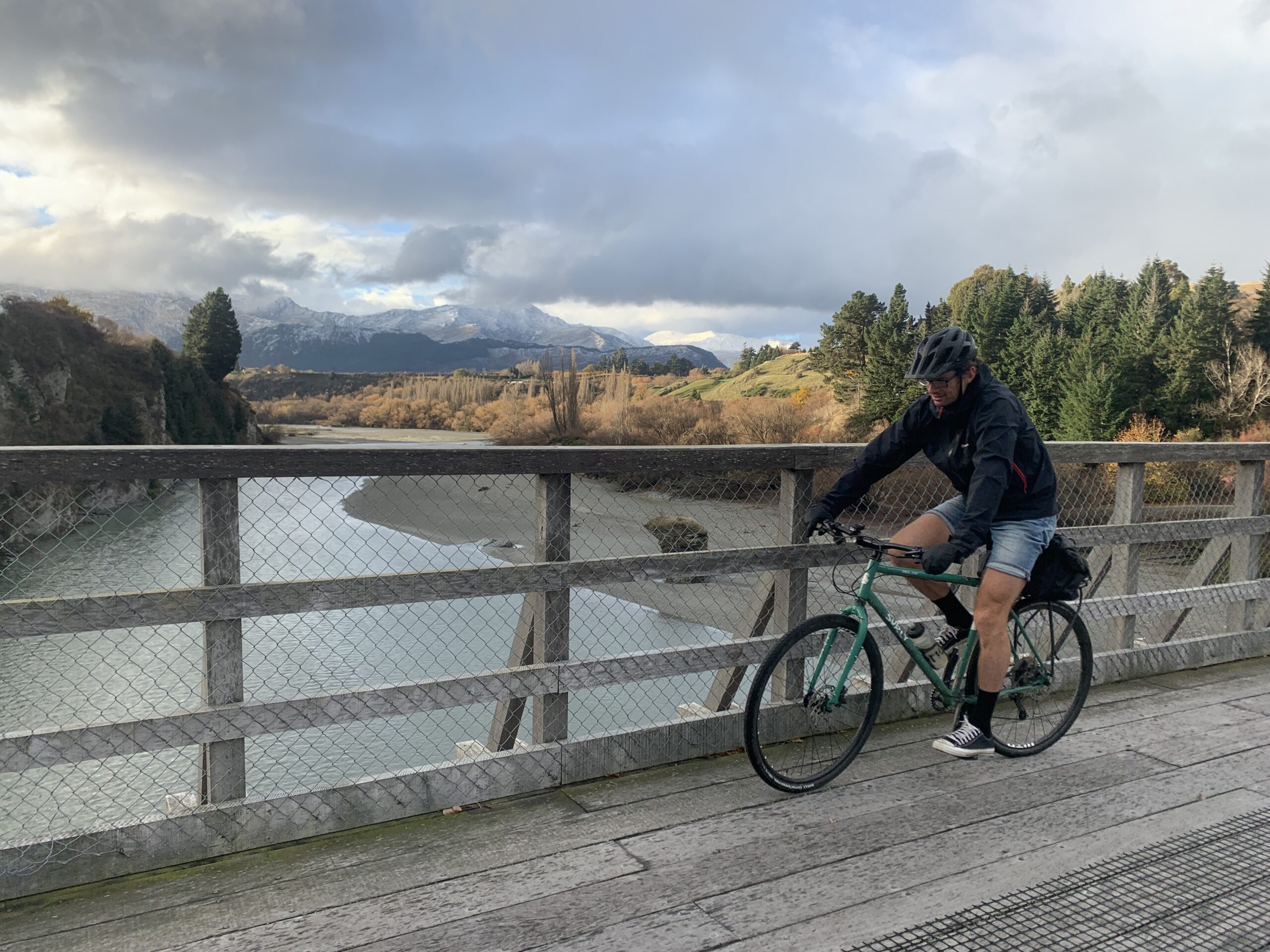 Paul Speedy crosses the Old Shotover Bridge on a Surly bike