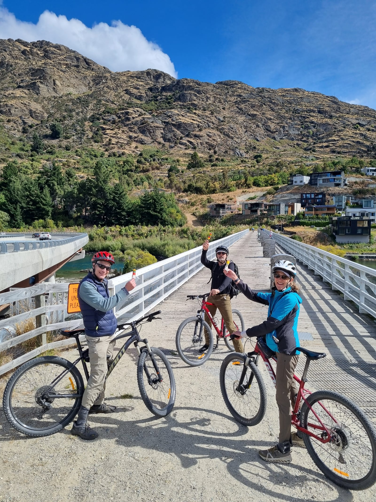 OneBike ABC2026 1 OneBike riders with their bikes on a shared path bridge